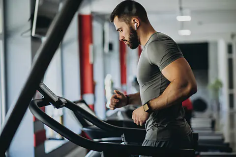 Man running on a treadmill in a gym