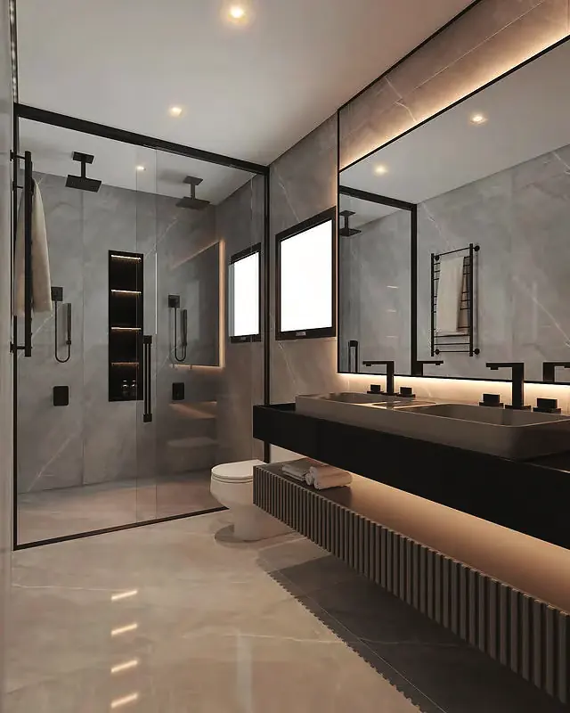 Bathroom with a glass shower enclosure, dark stone vanity and backlit mirror