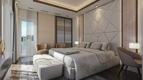 Bedroom with a geometric panelled headboard wall, lounge chair and sliding glass doors